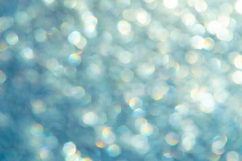 Bright glitter background: bokeh effect from many colored lights on frozen gl Stock Photos