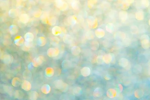 Bright glitter background: bokeh effect from many colored lights on frozen gl Stock Photos