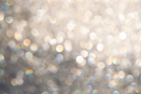 Bright glitter background: bokeh effect from many colored lights on frozen gl Stock Photos