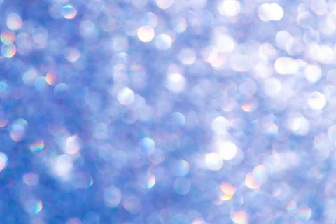 Bright glitter background: bokeh effect from many colored lights on frozen gl Stock Photos