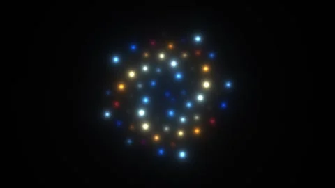 Bright glowing particles form a colorful pattern on a dark Stock Footage 338224171