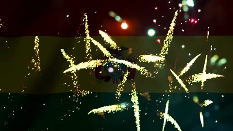 Bright golden fireworks exploding in front of the official national flag of.. Video stock 343690752