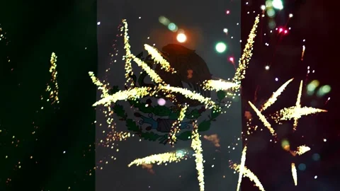 Bright golden fireworks exploding in front of the waving flag of Mexico Video stock 343690759