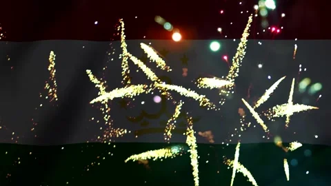 Bright golden fireworks exploding in front of the waving flag of Tajikistan Video stock 343690761