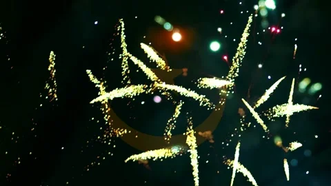 Bright golden fireworks exploding in the night sky behind a subtle Mauritan.. Video stock 343690763