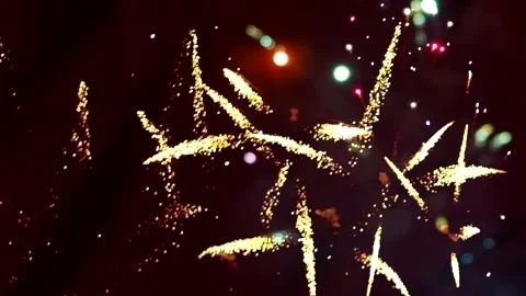 Bright golden fireworks exploding in the night sky during a celebration Vídeos de archivo 343690771
