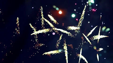 Bright golden fireworks exploding in the night sky during a festive celebrati Video stock 343690778
