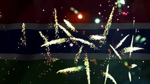 Bright golden fireworks exploding in the night sky over the waving national.. Stock Footage 343690894