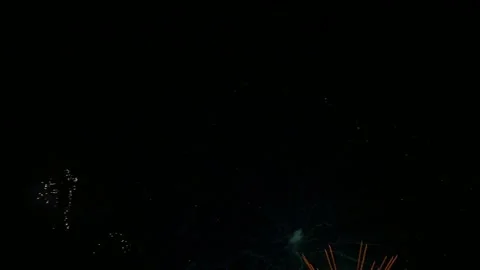 Bright golden fireworks exploding in the night sky during a celebration event Vídeos de archivo 345852794