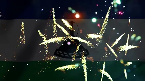 Bright golden fireworks exploding over the national flag of Lesotho in a ni.. Video stock 343690951