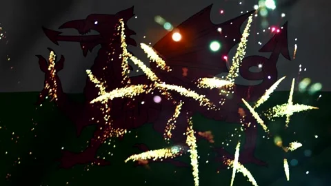 Bright golden fireworks exploding over the welsh flag featuring a red drago.. Video stock 343691004