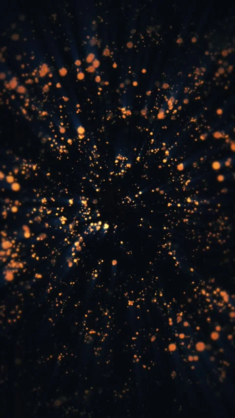 Bright golden orange particles float and glow against a deep black background Stock Footage 331304963