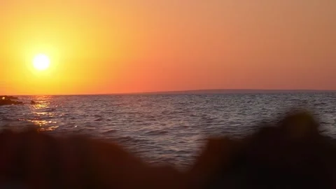 Bright golden sun setting slowly over calm ocean water horizon. Stock Footage 337406044