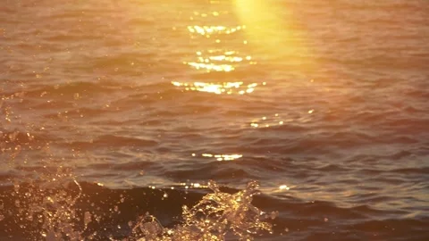 Bright golden sunlight reflections glisten over gentle calm ocean water. Stock Footage 337409947