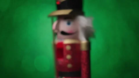 Bright green bokeh background sets the stage as the Toy Nutcracker spins with a Stock Footage 321681032