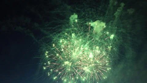 Bright green fireworks exploding in the night sky 库存照片