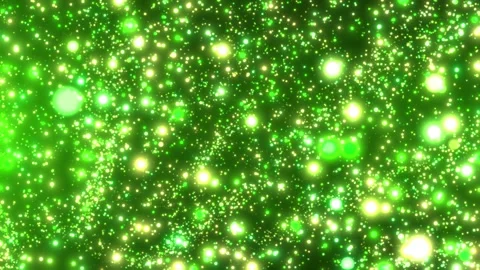 Bright green glowing particles sparkle across a dark space, creating a vibran Video stock 332802835