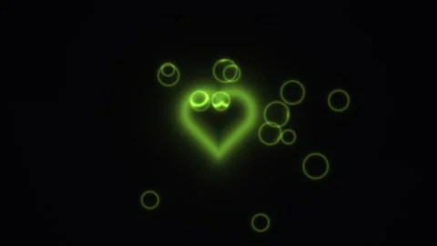 Bright green heart shape with glowing circles on dark Stock Footage 338225992