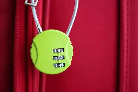 Bright green lock secures red suitcase with style and charm Stock Photos