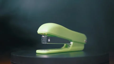 Bright Green Stapler Standing On Black Surface With Smoke Background Stock Footage 330113739