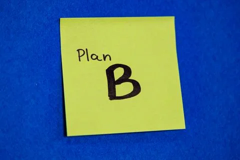 Bright green sticky note with handwritten text Plan B on blue felt background, a 写真素材