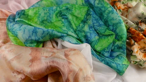 Bright green tie-dye silk fabric falls gently in slow motion. Stock-Footage 337406404