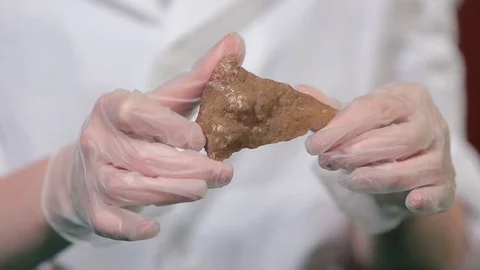 Bright grey ruby crystal ore in hands with gloves. Crystallization is the Stock Footage 79152265