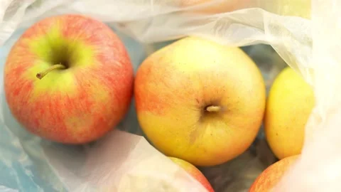 A bright, hazy macro close-up shot of fresh, ripe red-and-yellow apples Stock Footage 329616234
