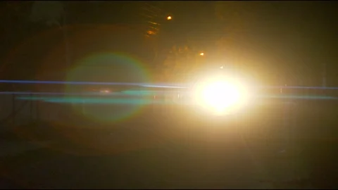 The bright headlight on the road. evening night time. anamorphic lens shot Stock Footage 80681159