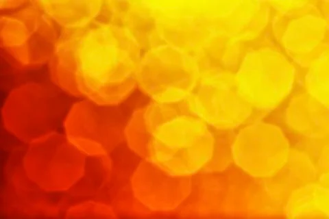 Bright hexagonal dark red and yellow color light bokeh Stock Photos