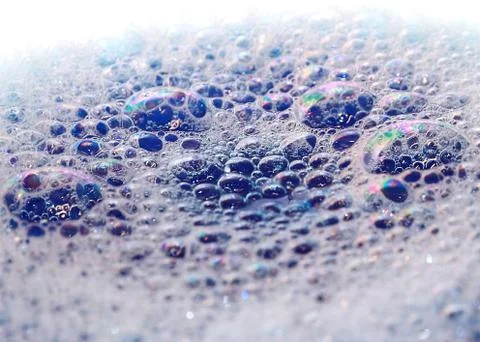Bright highlights on the surface of foam bubbles on the liquid Stock Photos