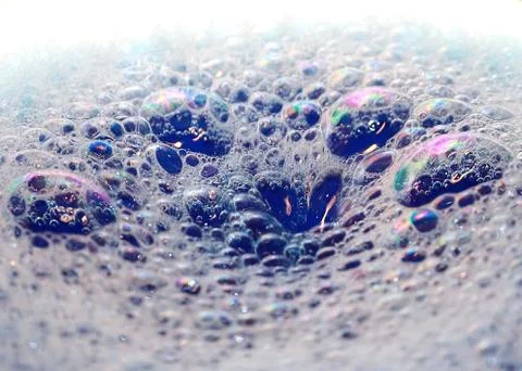 Bright highlights on the surface of foam bubbles on the liquid Stock Photos