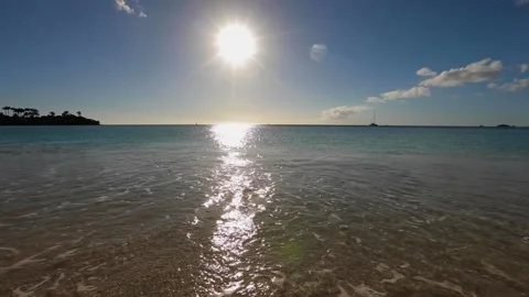 Bright huge sun strip, wave coming and going, calm warm idyllic ocean tide. Stock Footage 202120695
