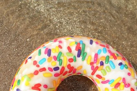 Bright inflatable doughnut ring floating on sea water, top view. Space for te 스톡 사진