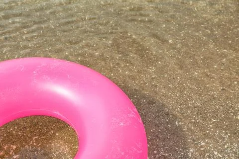 Bright inflatable ring floating on sea water. Space for text Stock-Fotos