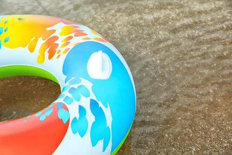 Bright inflatable ring floating on sea water. Space for text Stock-Fotos