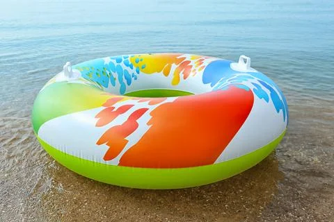 Bright inflatable ring floating on sea water. Summer vacation Stock Photos