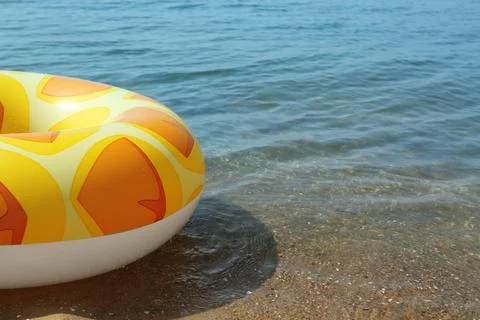 Bright inflatable ring floating on sea water. Space for text Foto stock