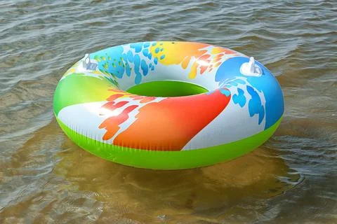 Bright inflatable ring floating on sea water. Summer vacation Stock Photos