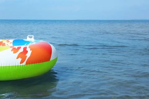 Bright inflatable ring floating on sea water. Space for text Stock-Fotos