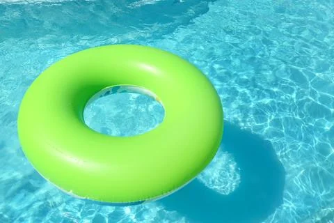 Bright inflatable ring floating in swimming pool on sunny day. Space for text Stock-Fotos