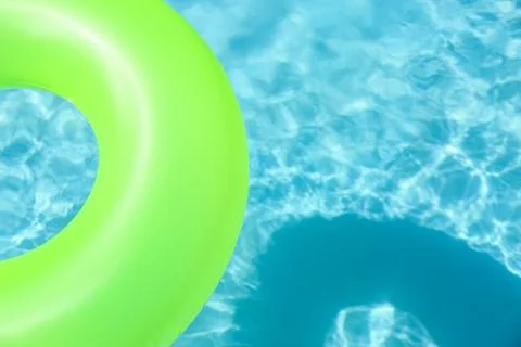 Bright inflatable ring floating in swimming pool on sunny day. Space for text Stock-Fotos