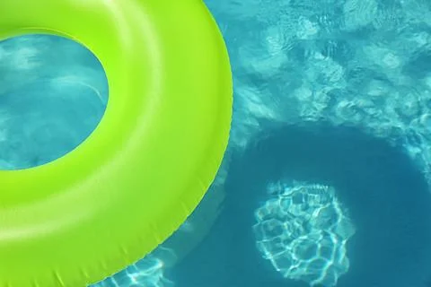 Bright inflatable ring floating in swimming pool on sunny day. Space for text Stock-Fotos