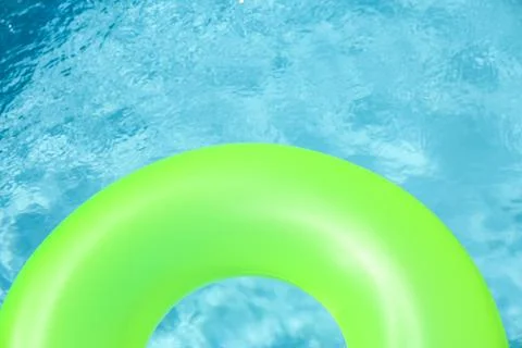 Bright inflatable ring floating in swimming pool on sunny day. Space for text Stock-Fotos
