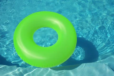 Bright inflatable ring floating in swimming pool on sunny day. Space for text Stock-Fotos