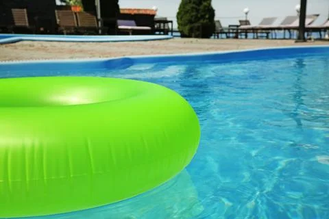 Bright inflatable ring floating in swimming pool on sunny day, outdoors. Spac 写真素材