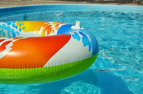 Bright inflatable ring floating in swimming pool on sunny day. Space for text Stock-Fotos