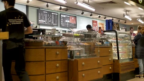 Bright interior of Caffè Nero coffee shop with glass display counters and a Stock Footage 297350981