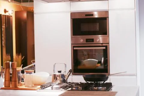 Bright interior kitchen with built-in oven. Beautiful white kitchen. Stock Photos