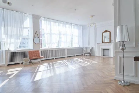 Bright interior with large windows and a fireplace in a classic style. Large Stock Photos